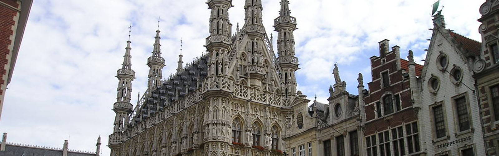 Top of the Leuven town hall building. It has very gothic and ornate architecture.